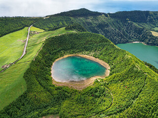 Picturesque aerial drone view of Lagoa Rasa and Lagoa Verde volcanic crater lakes. Turquoise water, forest and breathtaking green landscape. Sete Cidades, Sao Miguel, Azores, Portugal