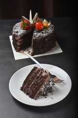 premium freshly baked dark cocoa chocolate brownie black forest blueberry jam round birthday cream cake with strawberry fruits on black table halal food sweet vegan dessert menu for pastry cafe shop