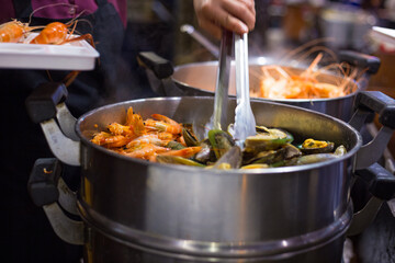 People hand take buffet food in hotel restuarant