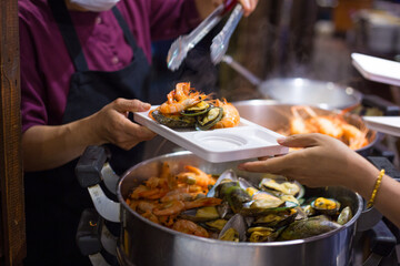 People hand take buffet food in hotel restuarant