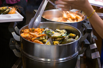 People hand take buffet food in hotel restuarant