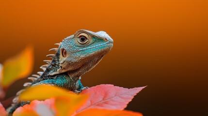 Obraz premium A tight shot of a lizard perched on a branch, surrounded by foreground leaves, against an orange-hued backdrop