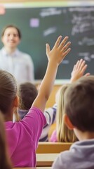 A photo of students raising their hands in class, the teacher smiling at them from the blackboard