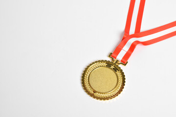 Gold medal with red and white ribbon isolated on white background. First place winner athlete....