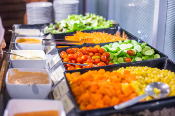 Colorful fresh vegetable salad bar with homemade sauces dressing