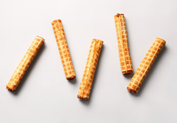 Tasty Wafer Rolls with Condensed Milk on White Background