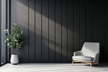 A minimalist room features a comfortable gray chair and a tall green plant by a black paneled wall with sunlight streaming in from the left.