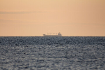 A shadow of the ship in the morning sea