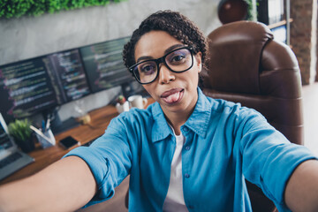 Photo of young woman tongue playful monitors coder selfie photo wear blue shirt modern office...