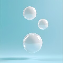 Three Opaque Floating Beads in Varying Sizes Against Soft Blue Background