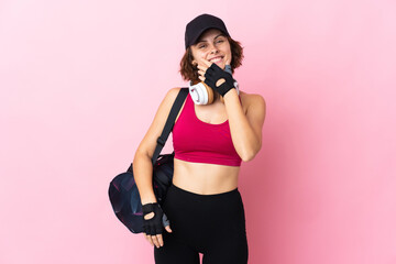 Obraz premium Young sport woman with sport bag over isolated background happy and smiling