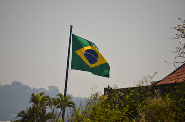 Flag of Brazil fluttering in the wind. In the center of the flag with the words "order and progress" in Portuguese. flag day. proclamation of the Republic. proclamação da república