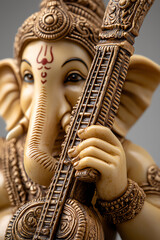 Fototapeta premium A detailed sculpture of the Hindu deity Ganesha playing the veena, adorned with intricate designs and symbolizing wisdom and creativity.