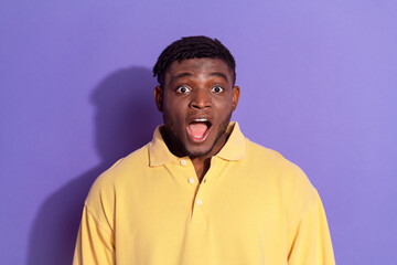 Photo portrait of attractive young man shocked open mouth dressed stylish yellow clothes isolated on violet color background