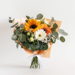 Vibrant bouquet of sunflowers, daisies, orange gerberas, and eucalyptus wrapped in paper, standing