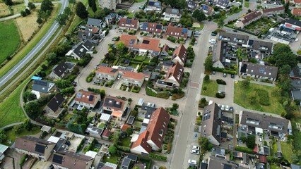 Aerial shot of houses with solar panels on roof in a street in a residential area neighborhood in Steenwijk, Overijssel, The Netherlands.