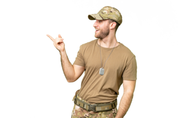 Military with dog tag over isolated chroma key background pointing finger to the side and presenting a product