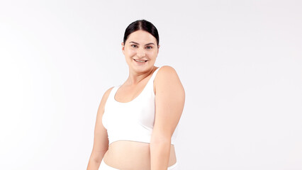 A vibrant, confident woman with a full figure poses against a bright backdrop. Perfect for showcasing diversity and promoting body positivity. Ideal for health and lifestyle campaigns.