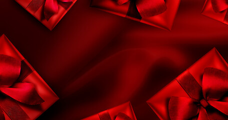 Rotes Geschenk mit Schleife vor Rotem Hintergrund