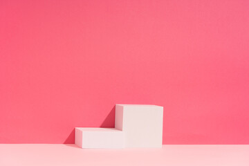 Beauty Cosmetics Product Presentation Stage made with White Cubes on a Pink Backdrop. Studio Photography.