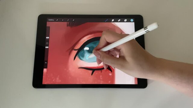 hand drawing a digital illustration on a tablet with a digital pen