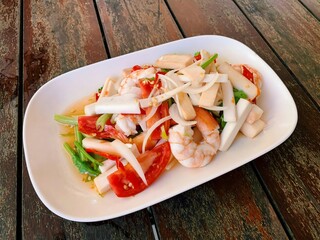 Spicy Thai Salad with Shrimp and Young Coconut Shoots on a Wooden Table, Thai Food.