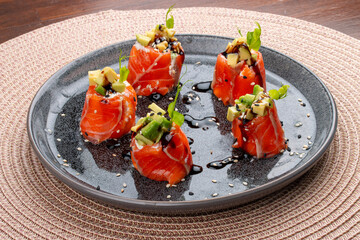 Delicate slices of smoked salmon wrapped around a creamy filling of cream cheese and ripe avocado.