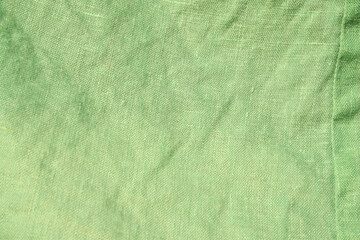 Creative background made of green linen fabric