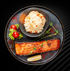 Salmon steak with creamy rice. A succulent salmon fillet, perfectly grilled or pan-seared, served alongside a bed of rich, creamy rice.
