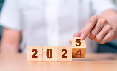 Hands holding blocks with 2025 year change sign