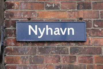 Obraz premium Text in Danish language NYHAVN which means new harbour is the district of Copenhagen in Denmark with the canal and coloured houses