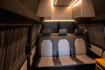 Comfortable interior of a passenger bus with soft seats. The design is made to order. Private covering of cars. Various elements of the bus interior.