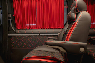 Comfortable interior of a passenger bus with soft seats. The design is made to order. Private...