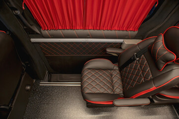 Comfortable interior of a passenger bus with soft seats. The design is made to order. Private...