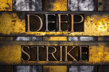 Deep Strike text in real authentic typeset letters on vintage textured silver grunge copper and gold background