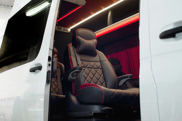 Comfortable interior of a passenger bus with soft seats. The design is made to order. Private...