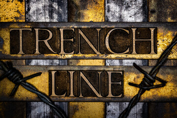 Trench Line text with barbed wire in real authentic typeset letters on vintage textured silver grunge copper and gold background