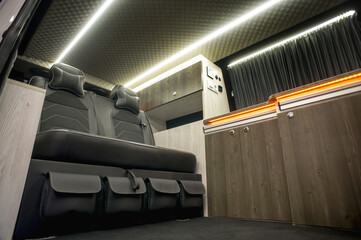 Comfortable interior of a passenger bus with soft seats. The design is made to order. Private...