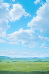 A beautiful grassland background with a blue sky and white clouds, green meadows, and distant hills. 