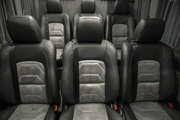 Fototapeta premium Comfortable interior of a passenger bus with soft seats. The design is made to order. Private covering of cars. Various elements of the bus interior.