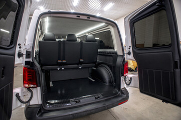 Comfortable interior of a passenger bus with soft seats. The design is made to order. Private...