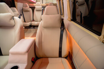 Comfortable interior of a passenger bus with soft seats. The design is made to order. Private covering of cars. Various elements of the bus interior.
