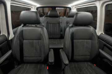 Comfortable interior of a passenger bus with soft seats. The design is made to order. Private covering of cars. Various elements of the bus interior.