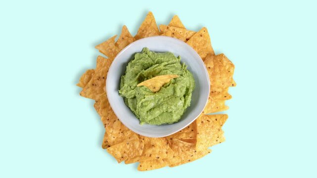 A bowl of guacamole with tortilla chips