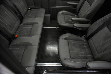 Comfortable interior of a passenger bus with soft seats. The design is made to order. Private covering of cars. Various elements of the bus interior.