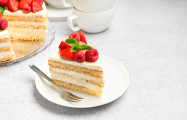 Piece of tasty sponge cake with fresh berries and mint served on light gray table, space for text