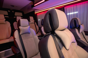 Comfortable interior of a passenger bus with soft seats. The design is made to order. Private...