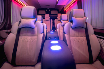 Obraz premium Comfortable interior of a passenger bus with soft seats. The design is made to order. Private covering of cars. Various elements of the bus interior.