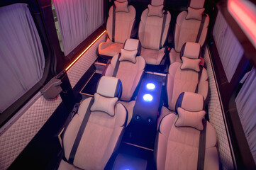 Comfortable interior of a passenger bus with soft seats. The design is made to order. Private...