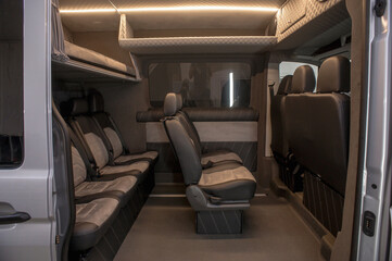Comfortable interior of a passenger bus with soft seats. The design is made to order. Private covering of cars. Various elements of the bus interior.